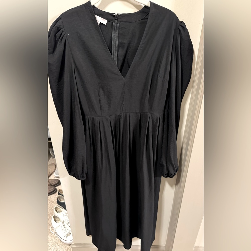 Women's black dress. Deep v-neck with puff shoulders and billowed sleeves